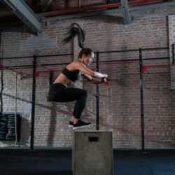 Woman doing box jumping in the gym
