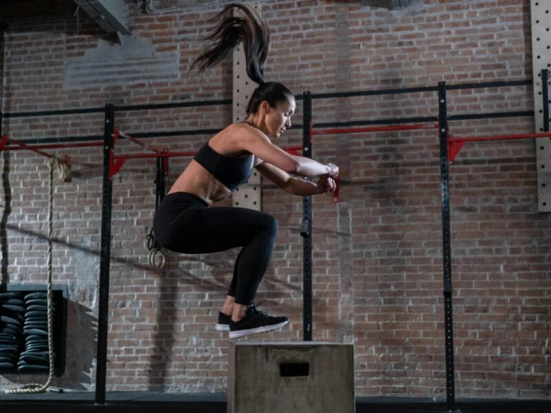 Woman doing box jumping in the gym
